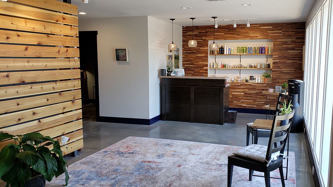 The Indigo Water salon interior with wood-slat walls and styling chair