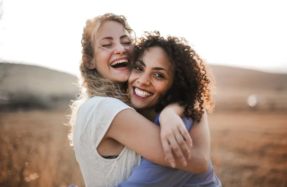 Two friends smiling outdoors